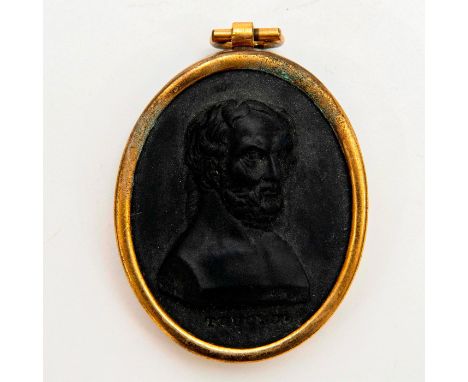 Black medallion featuring a cameo bust of Thucyd, Athenian historian, with name below portrait set in a patinated brass frame