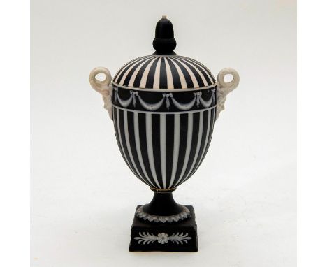 Model 26. Black and white, with engine turning and white interior. Depicts Bacchus in relief as handles. Wedgwood impressed b