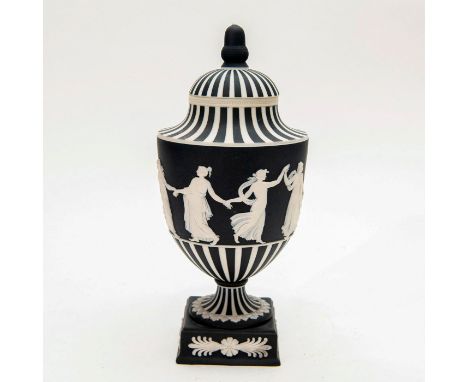 Model 1202. Black and white, with engine turning and white interior. Depicts classically dressed women dancing in relief. Wed