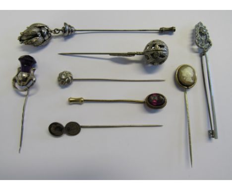 A collection of eight stick/hat pins to include a marked silver Scottish design stick pin hallmarked for Birmingham 1910 and 