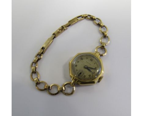 ROLEX - An 18ct gold octagonal cased ladies manual wind Rolex watch with cream dial, sub seconds dial and blue batons. The ou