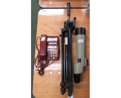 Spotting telescope with tripod together with a push button telephone