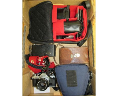 A Classic Canon SLR Camera AE1 with 50mm lens, a folding Kodak Brownie in case and a bag containing additional lenses and var