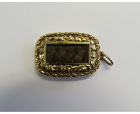 Memorial - A Victorian unmarked gold (tested) pendant piece of oblong form set with a glass fronted panel containing plaited 