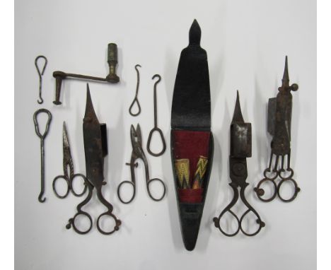 Three early candle snuffers, a scissor holder, button hooks, scissors etc.