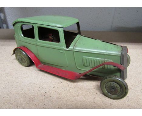 Triang Toys tinplate saloon car No. 541?  Painted green and red with lithographed tyres and driver.  Complete with working cl