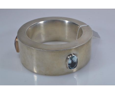 Custom made heavy white metal statement bangle, bezel-set with three large topaz stones, including blue (17 x 12mm), green (1
