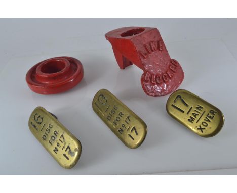 Three brass lever plates, two marked GWR & Line blocked cast metal cover and other round cast metal item. 