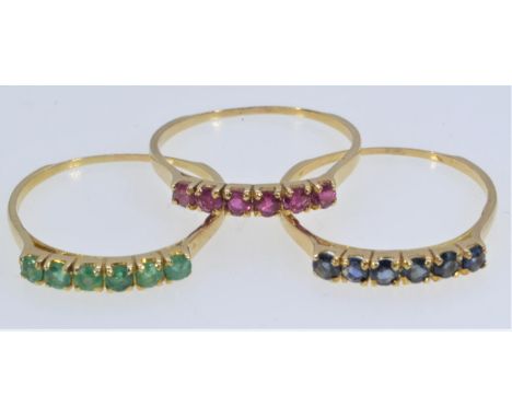Three yellow metal gem-set rings, each set with six emeralds, sapphires & rubies respectively, tests positive for 14ct gold, 