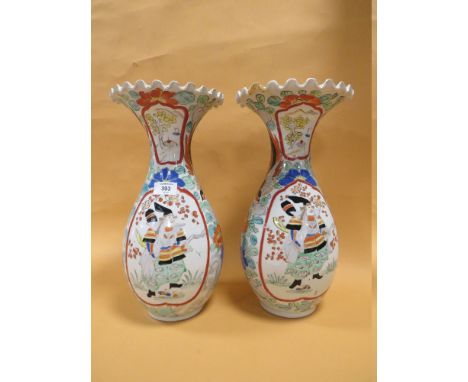 A PAIR OF ORIENTAL BALUSTER VASES WITH FRILLED RIMS, each vase decorated with a figure in a shaped cartouche, amidst floral d