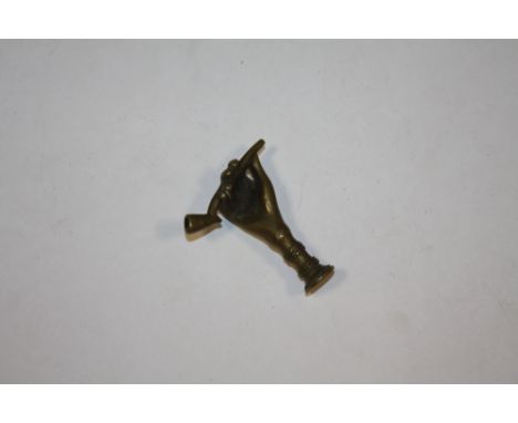 A VINTAGE BRASS PIPE TAMPER IN THE FORM OF A HAND 