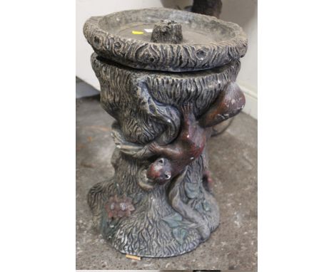 A TREE TRUNK DESIGN BIRD BATH WITH SQUIRREL FIGURES