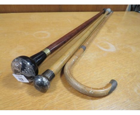 A HALLMARKED SILVER TOPPED WALKING CANE, TOGETHER WITH ANOTHER AND A WHITE METAL BANDED WALKING STICK (3)