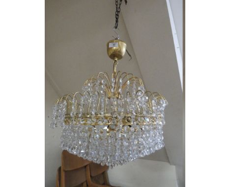 A MODERN GILT CRYSTAL CHANDELIER 