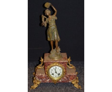 A 19th century French mantel clock surmounted with a spelter musician titled Gitana by Par Guillemin, rouge marble casing wit