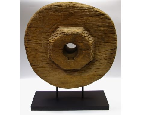 Architectural Salvage - an unusual wooden cartwheel, mounted on a black rectangular stand, 59cm high 