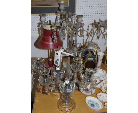 A reproduction candle lamp; a wrought iron three branch candelabrum; a pair of glass two branch candelabra; a modern three li