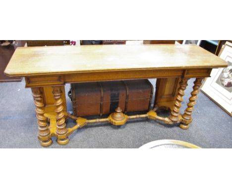 An oak serving table, inverted break front frieze, writhen forelegs, turned X-frame stretchers and under finial.