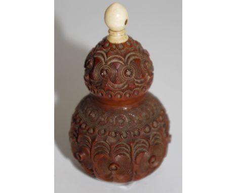 A 19th century carved cocquilla nut of gourd form, bone finial inset with a stanhope 9cm height 
