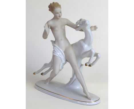 A Goebel Art Deco style figurine Modelled in the form of a semi-nude female beside a leaping gazelle, green factory marks to 
