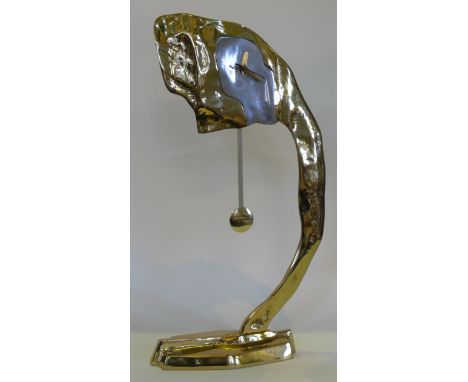 David Marshall (b.1942) contemporary sculptural clockModelled in the form of an arched arm in gilt with a shaped steel finish