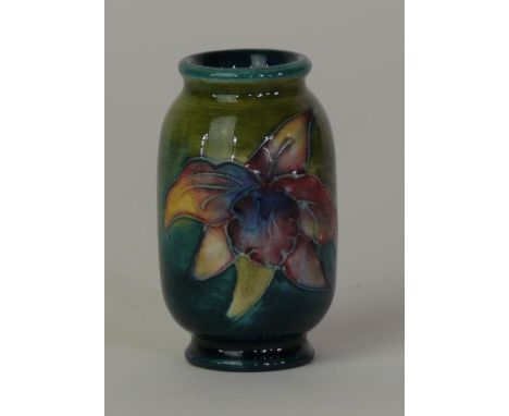 A Walter Moorcroft miniature vase of cylindrical formDecorated in the 'Orchid' pattern on a green ground, blue printed factor