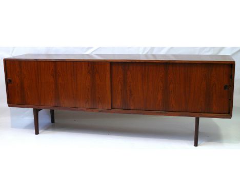 A fine quality Danish rosewood sideboardCirca 1960's, of rectangular form having two large sliding doors enclosing single adj