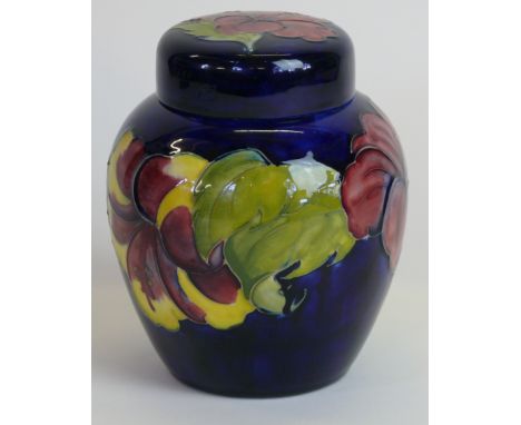 A Walter Moorcroft pottery ginger jar and coverDecorated in the Hibiscus pattern on a blue ground, impressed factory marks to