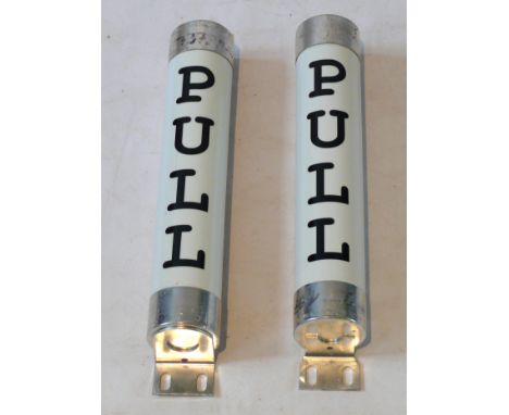 A pair of contemporary industrial ceramic door handlesEach of cylindrical form with steel mounts, length 47cm.