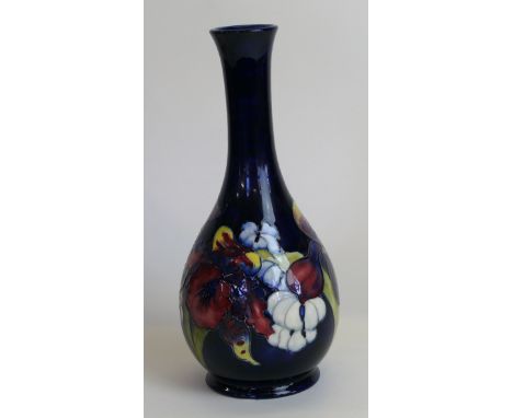 A Walter Moorcroft pottery vase of baluster form with cylindrical neckDecorated in the Orchid pattern on a blue ground, print