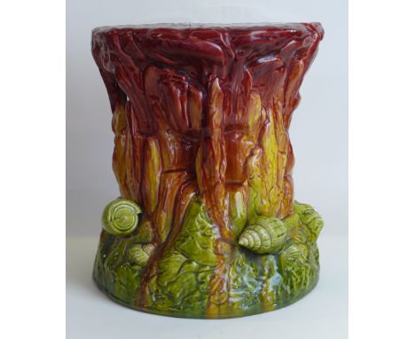 A Bretby art pottery garden seatModelled in relief with shells and naturalistic motifs on a Majolica glazed ground, impressed