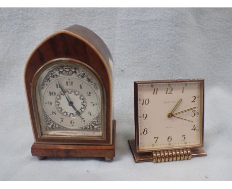 AN EARLY 20TH CENTURY WALNUT-CASED  ALARM CLOCK in  the form of a miniature bracket clock with silvered dial 13 cm high (not 