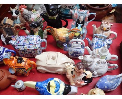A TONY WOOD 'PUSSYFOOT' TEAPOT a racing car teapot, and other novelty teapots (some have damage)