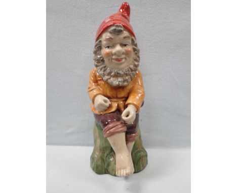 A REPRODUCTION GLAZED CERAMIC GARDEN GNOME 42 cm high