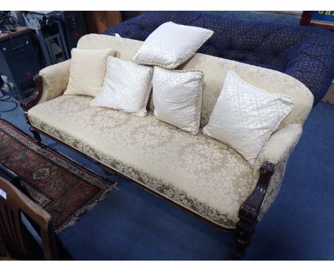 A VICTORIAN SOFA WITH CARVED WALNUT SHOW FRAME 190 cm long (some losses to carving, marks to upholstery)