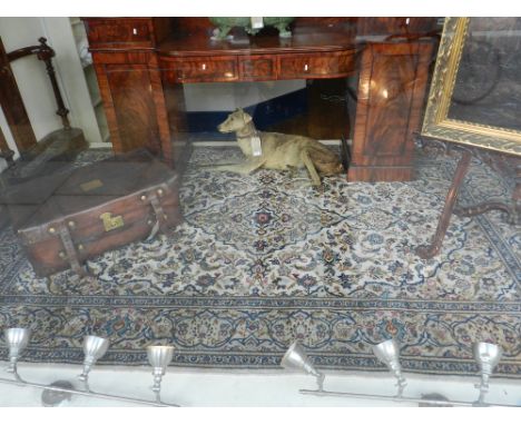 A cream ground Indian carpet, decorated in the Nain palette, having floral teardrop medallions to centre on a scrolling folia