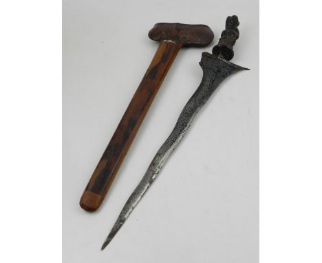 A 19th century Indonesian kris, with a typical 'marbled' shaped blade within a hardwood scabbard, the horn handle modelled in