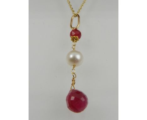 A yellow metal, ruby, and pearl drop pendant, suspended on a yellow metal chain. 