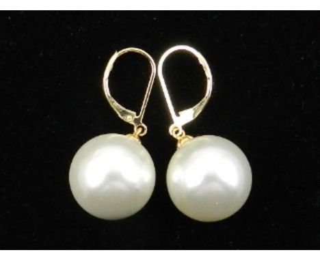 A pair of yellow metal and shell-covered pearl style drop earrings, the shanks stamps 14k.