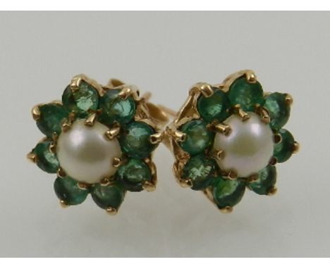 A pair of 9 carat yellow gold, emerald, and pearl cluster earrings.