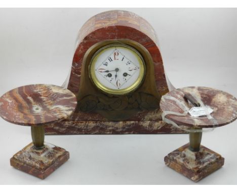 An early 20th century red marble mantel clock, the white enamel dial set out with Arabic numerals in a lozenge, en suite with