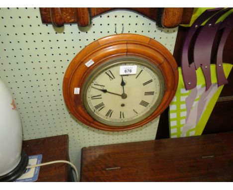 A small circular oak framed wall clock 