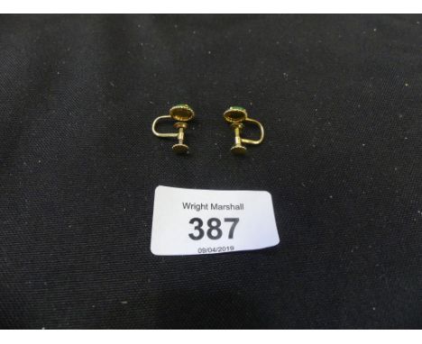 A pair of jade earringsEach designed as a jadeite jade disc with textured surround and screw fittings, stamped 9K, weight app