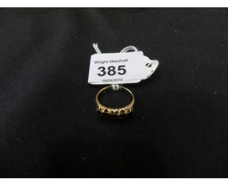 A garnet five stone ringThe cushion shape garnet line with tapered shoulders, stamped, hallmarks rubbed, ring size K, weight 