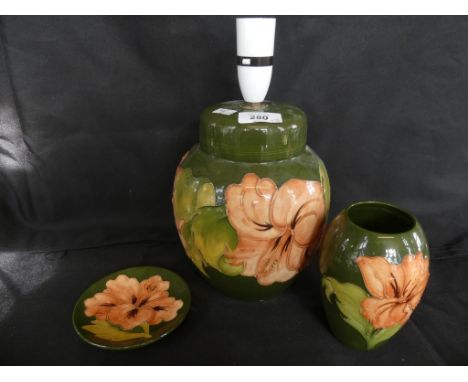 A Moorcroft Hibiscus pattern table lamp, together with a similar vase and circular dish (3) 