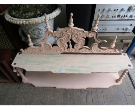 A shabby chic painted shelf unit, having spindle supports 