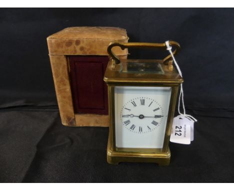 A late 19th/early 20th Century brass four glass carriage clock the white enamelled dial with Roman numerals, brass movement s