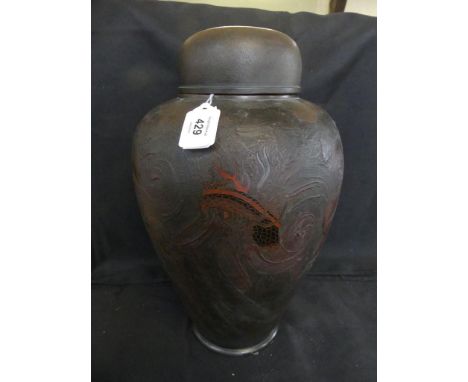 A Chinese ceramic jar and coverRelief decorated with a dragon on a textured ground, height 35cm.ADDITIONAL INFO/CONDITION REP