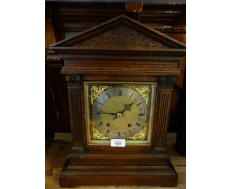 A late 19th/early 20th Century oak cased bracket clock with brass and silvered dial, with twin train brass movement 