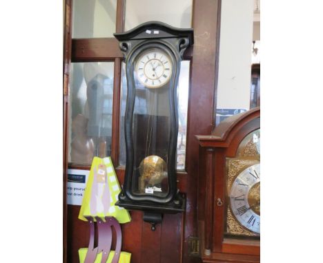 A Vienna wall clock, inset into a dark finish frame 